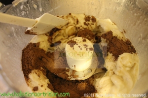 Place frozen bananas,  milk, and carob powder in food processor. 